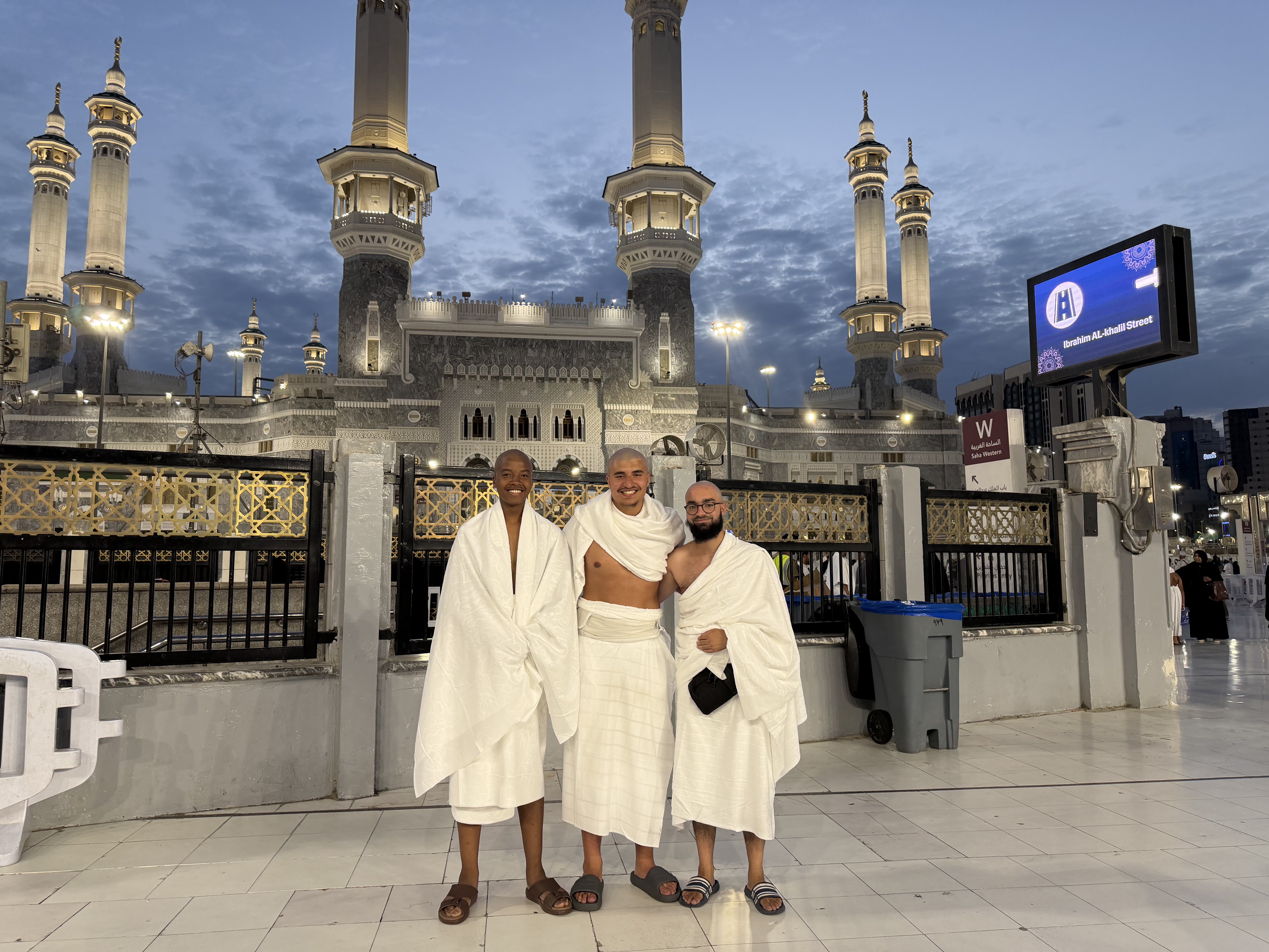 Three Rawdah Tours pilgrims in ihram outside Masjid al-Haram in Makkah